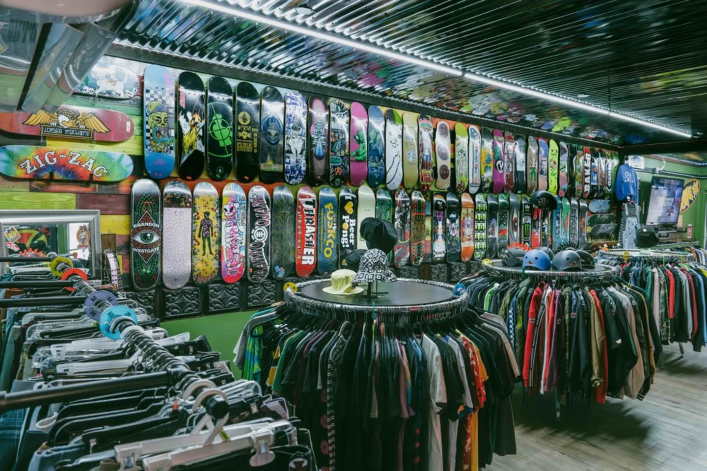 Inside Broke Sk8 with a wall of skateboard decks, apparel racks, and shop displays