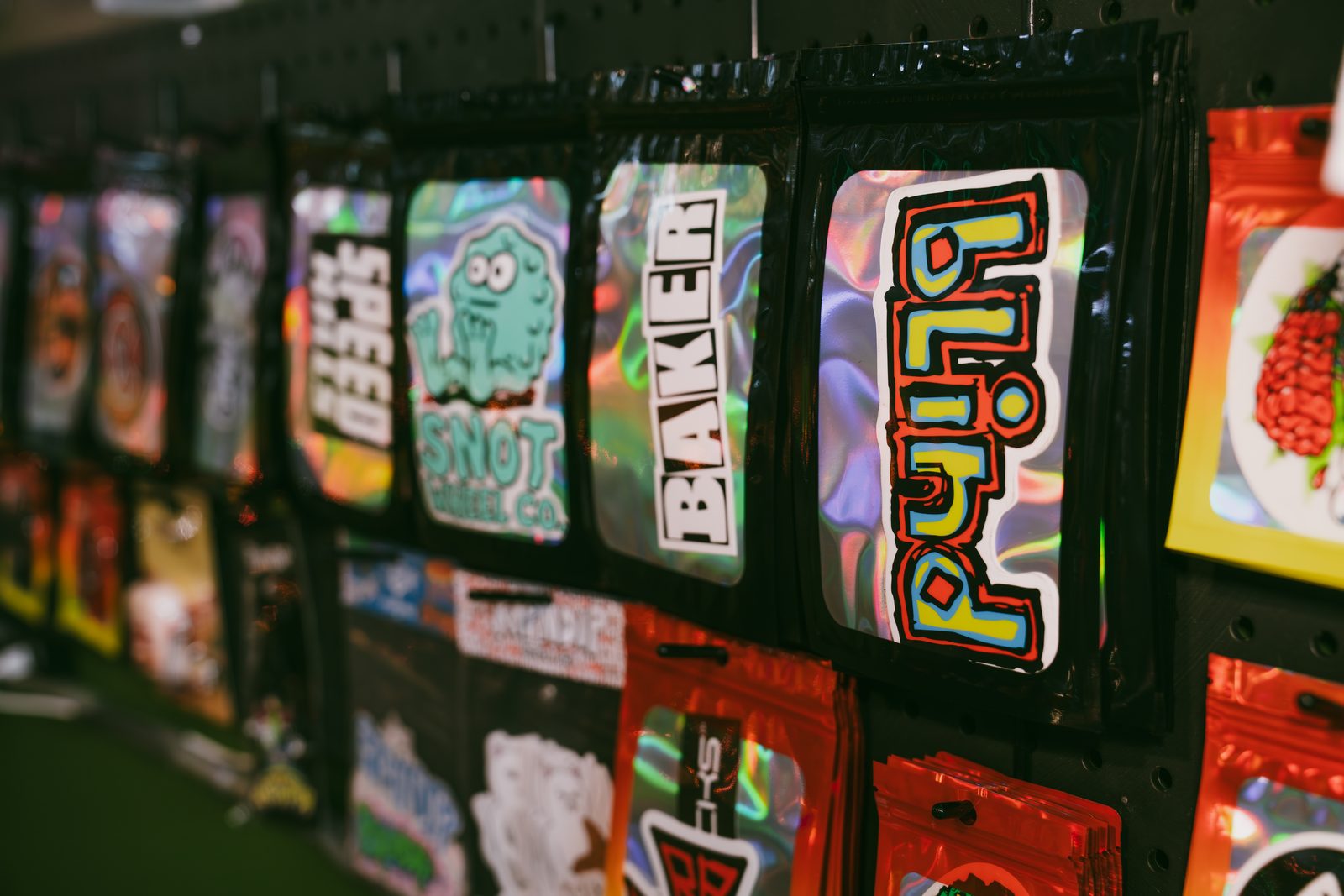 Wheel packets and small goods on the pegboard at Broke Sk8