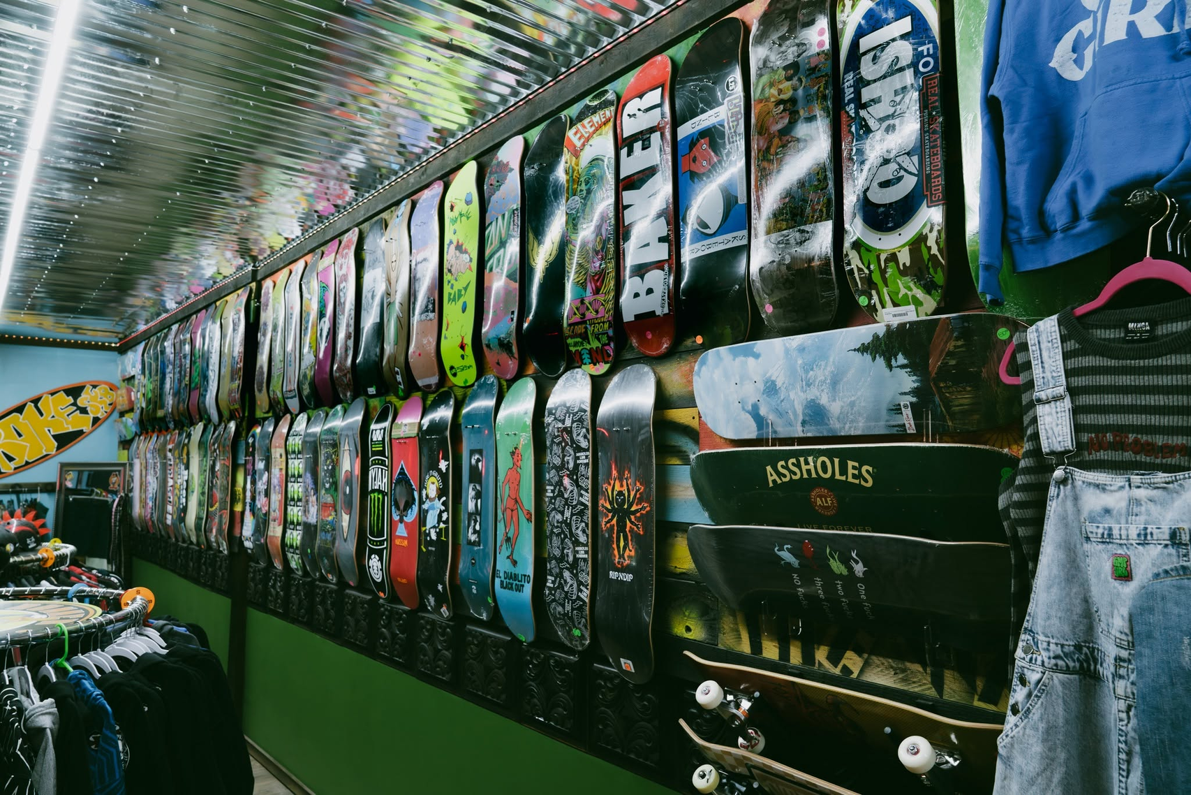 Rows of skateboard decks displayed on the Broke Sk8 shop wall
